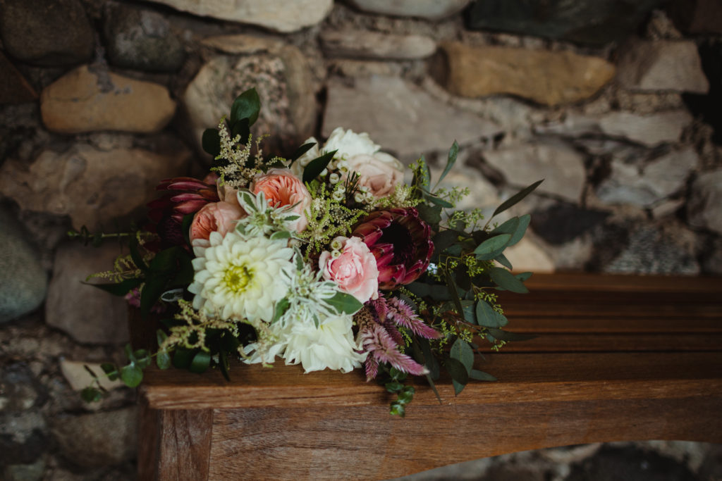 Bouquet of flowers sitting on a bench at Castle Farms in Charlevoix Michigan. Essential to dos once you're engaged!