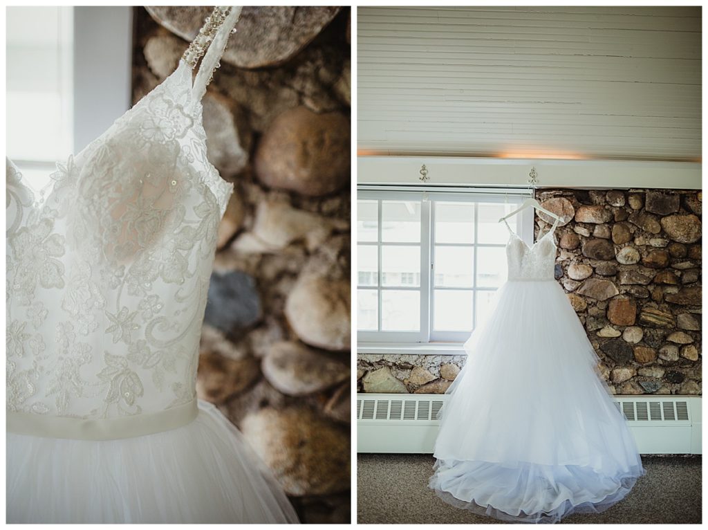 photo of white wedding dress in front of stone wall