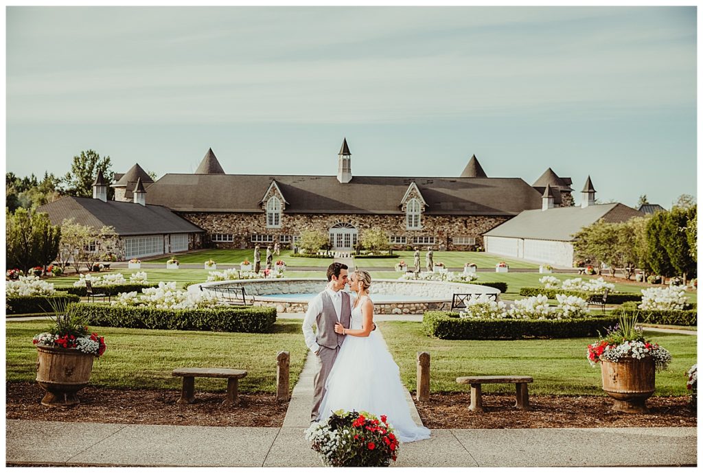 bride and groom in front of castle farms